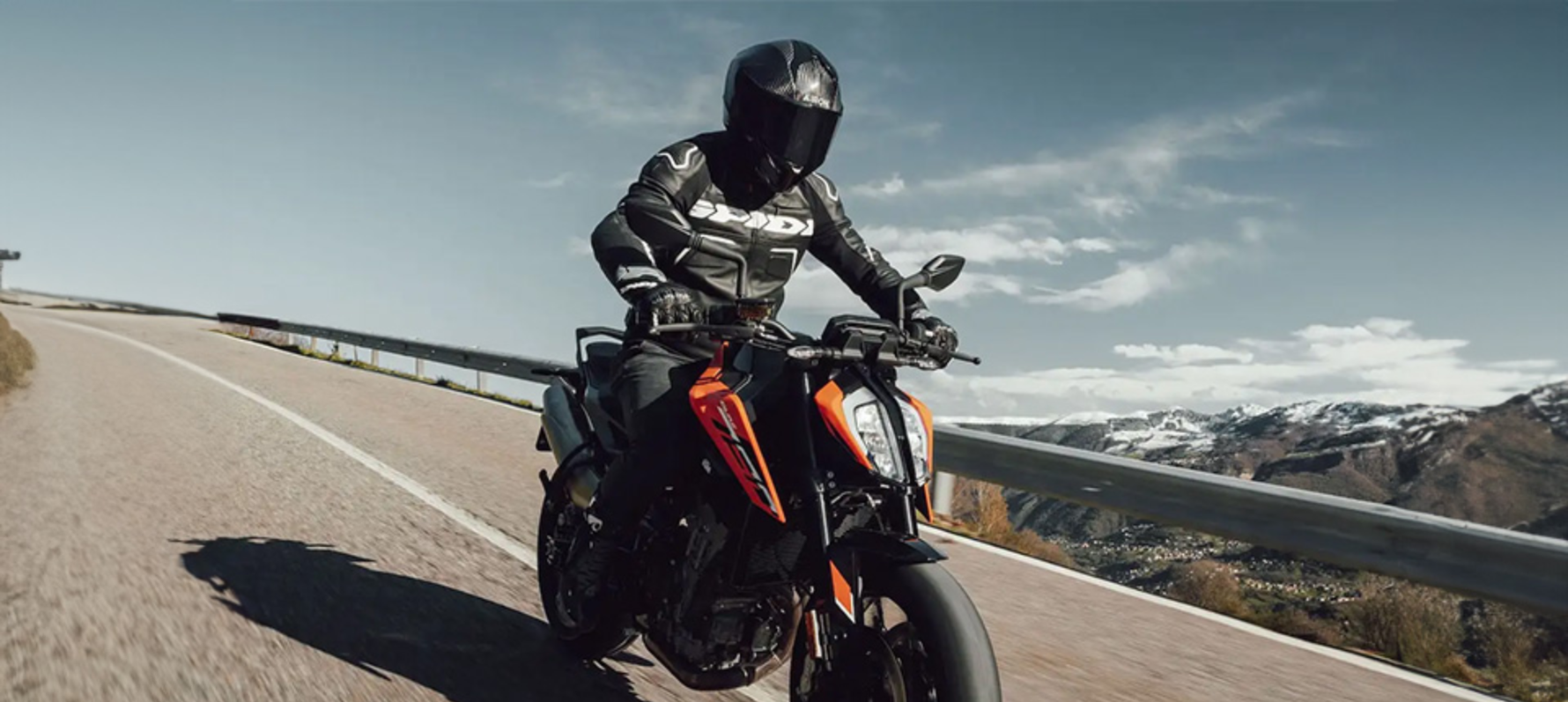 Person riding motorcycle whilst wearing Airoh Matryx Carbon helmet.