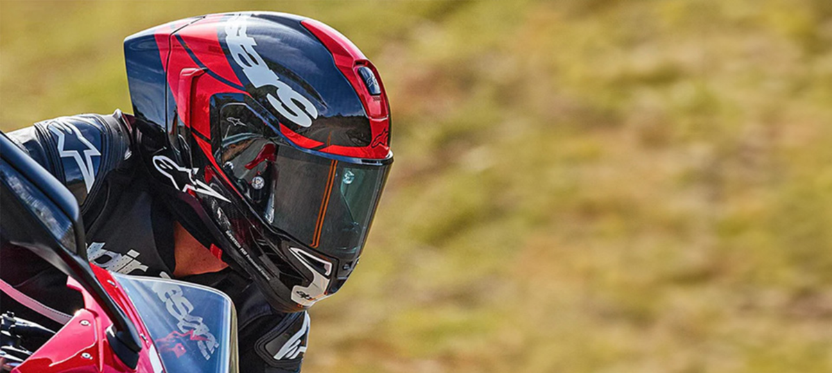 Close up of motorcycle rider wearing Alpinestars Supertech R10 helmet.