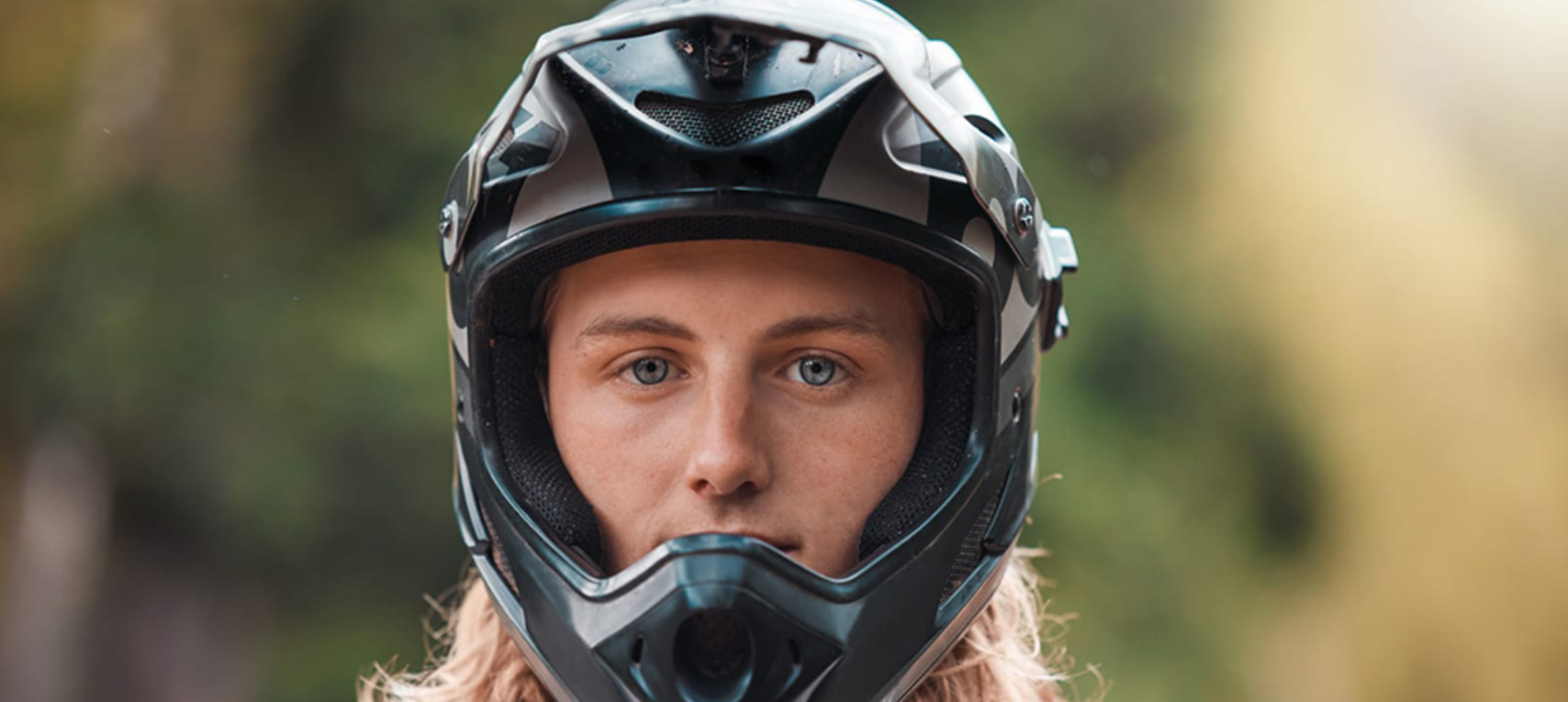 Person stood looking forward wearing a motocross helmet.
