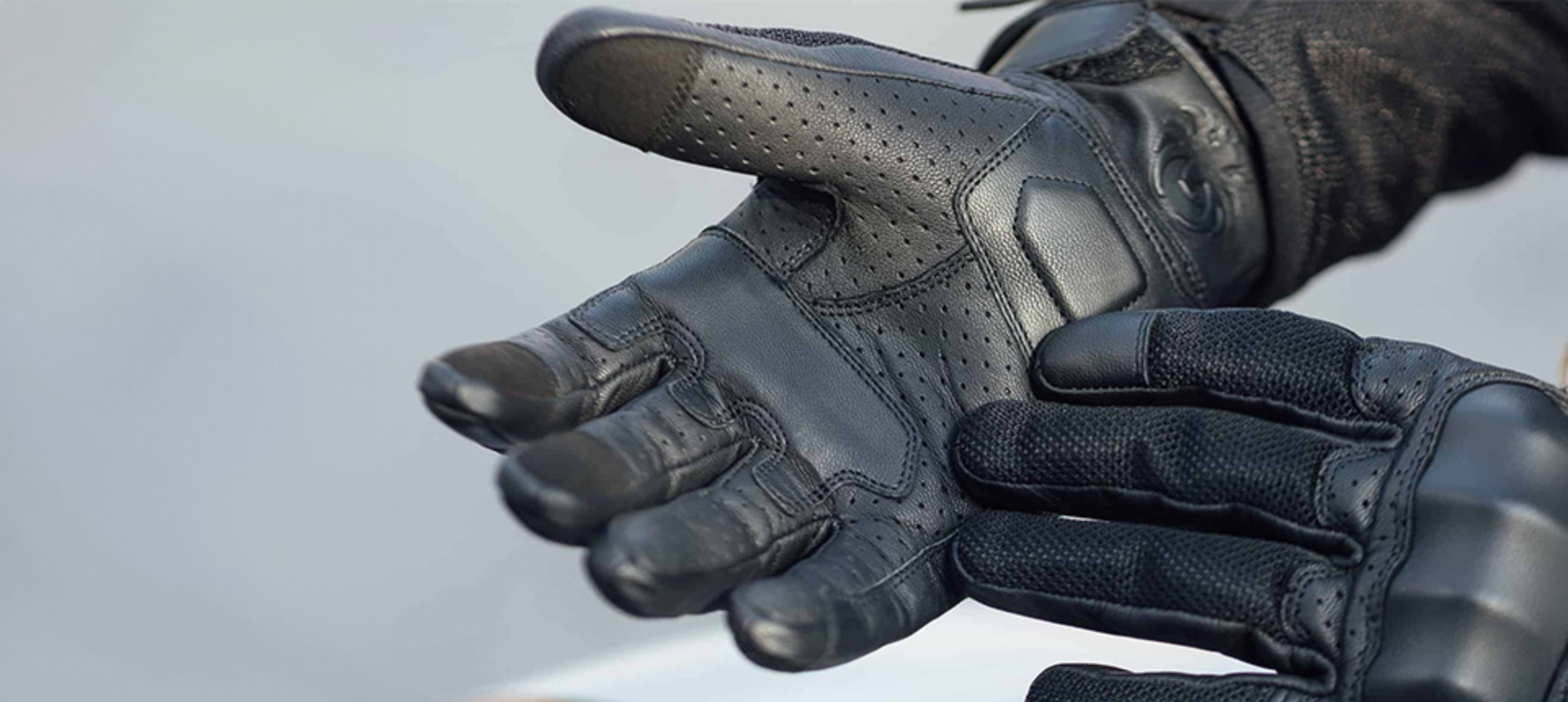 Close up of somebody wearing motorcycle gloves. 