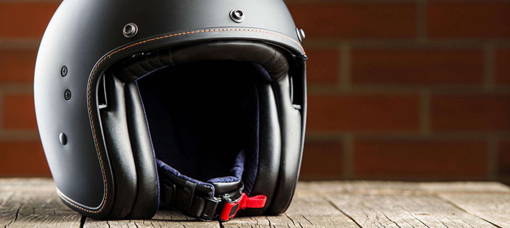 Open face helmet sat on top of a wooden table.