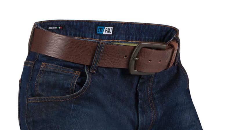 A dark brown textured leather belt with a black metal buckle, shown worn around the waist of dark blue jeans against a white background.