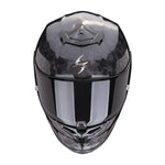 Black motorcycle helmet with a reflective visor on a white background