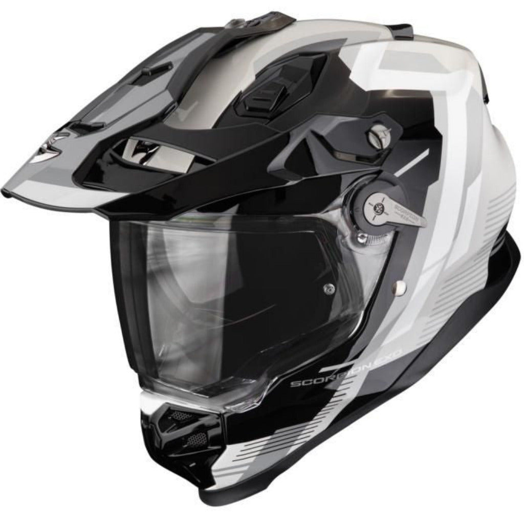 A full-face off-road motorcycle helmet in a glossy black and white color scheme, featuring a clear visor and visible 'SCORPION' branding on the lower front.