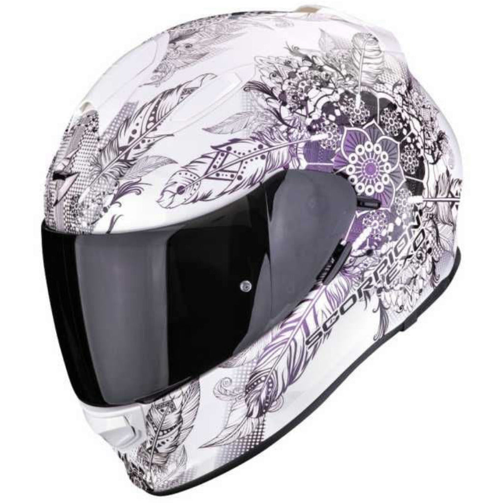 Motorcycle helmet with floral and feather design on a white background