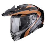 Black and orange motorcycle helmet with visor on a white background