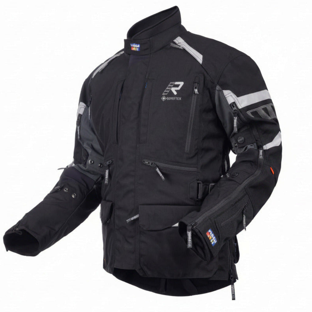 A black Gore-Tex motorcycle jacket with gray and white reflective panels, shown on a plain white background.