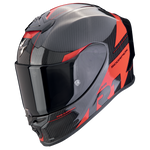 A full-face motorcycle helmet in a glossy black and red carbon fiber pattern, featuring a dark visor and visible 'SCORPION' branding on the side.