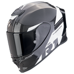 A carbon fiber full-face motorcycle helmet with a glossy black visor, featuring white and gray graphic accents and the 'SCORPION' brand name on the side.