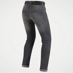 A pair of dark gray slim-fit jeans shown from the back, featuring a faded wash on the thighs and cuffed hems, set against a plain white background.