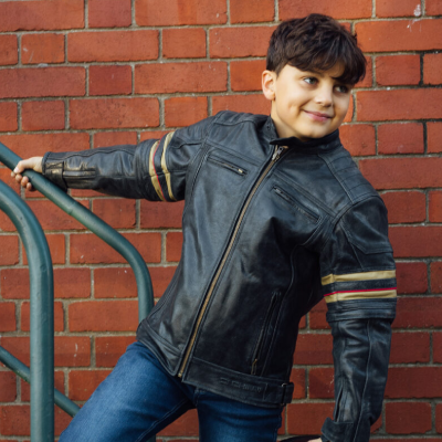 Styled photo of child wearing junior motorcycle jacket.