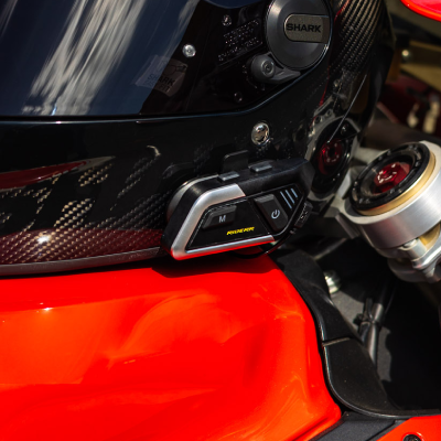Close up of intercom attached to motorcycle helmet.