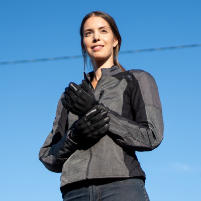 Woman stood wearing summer motorcycle jacket.