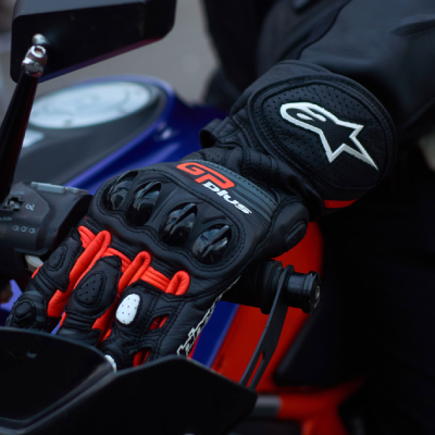 Close up of rider wearing Alpinestars motorcycle gloves.