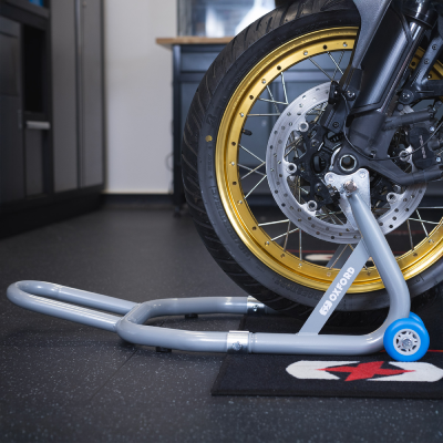 Motorcycle stood on front paddock stand.
