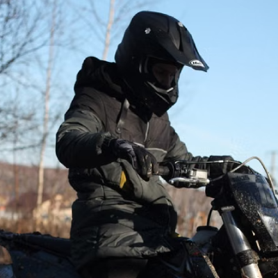 Rider on motorcycle wearing off road jacket.