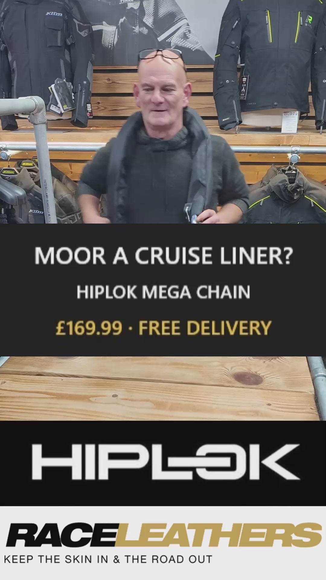 Keith from RaceLeathers Motorcycle Clothing demonstrating the Hiplok Mega Chain at the store in Darwen Lancashire